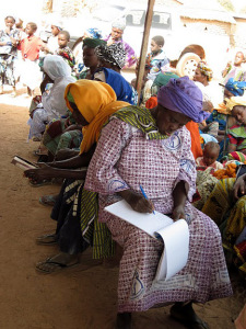 women's cooperative members take notes during Farmer-to-Farmer training