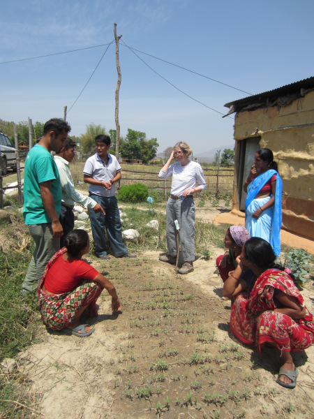 Amar in the field with a volunteer and trainees