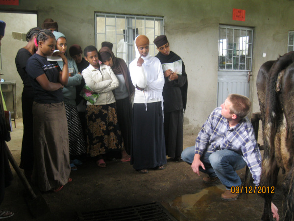Volunteer Hans Schmitz talks with Sebeta Getesemani Nunnery/Orphanage staff and youth about improved dairy practices