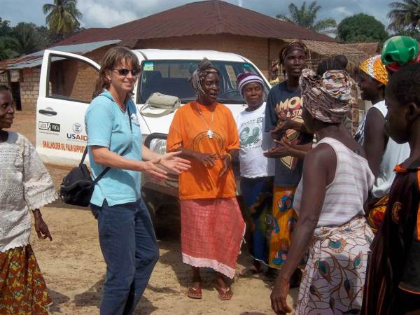 Volunteer Kevyn Wightman greeted by village farmers