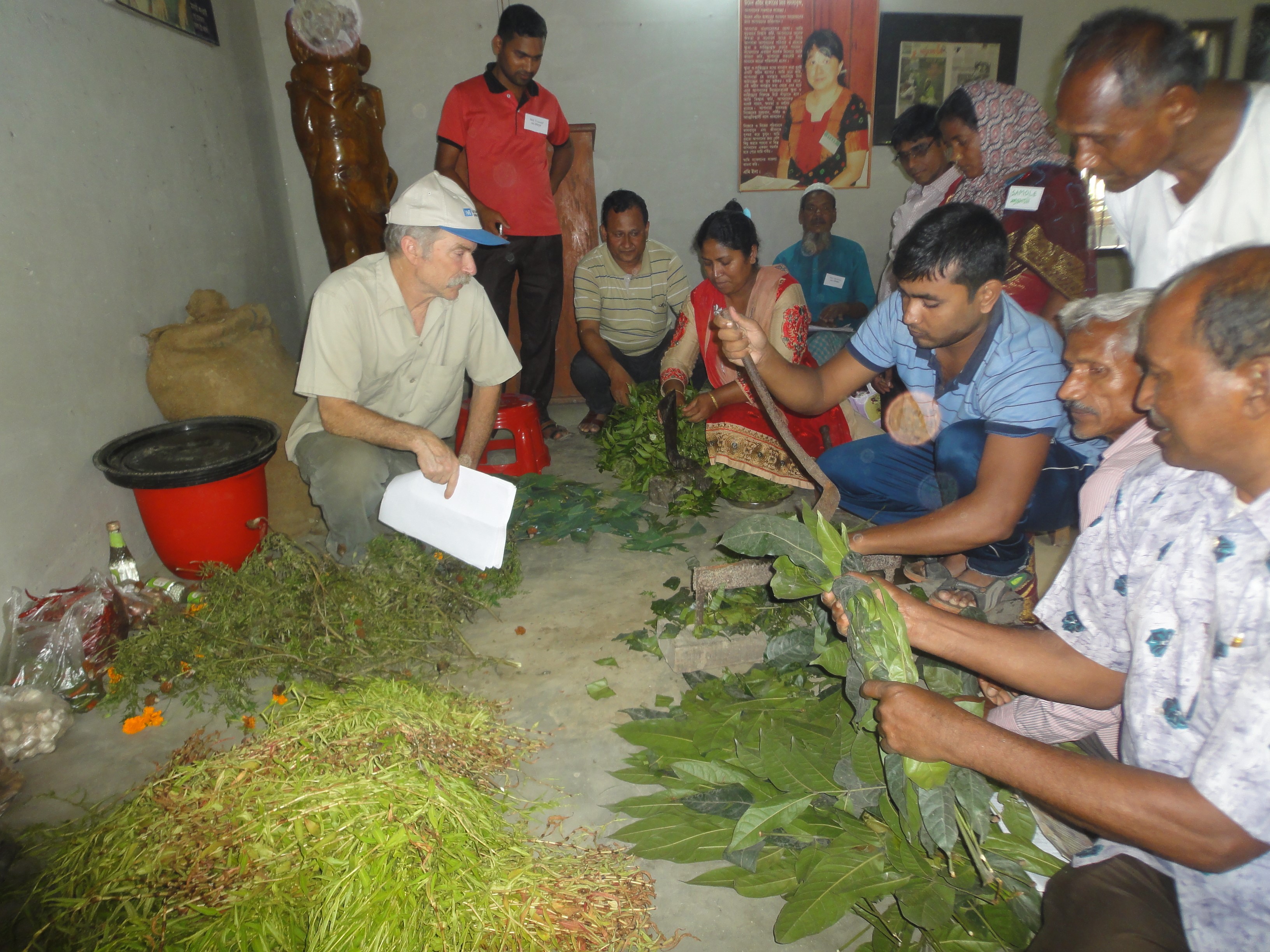 Charles Mitchell giving instructions on how to prepare an insect repellent using organic ingredients and various plant leaves to spay any kind of plant or crop to control insects.