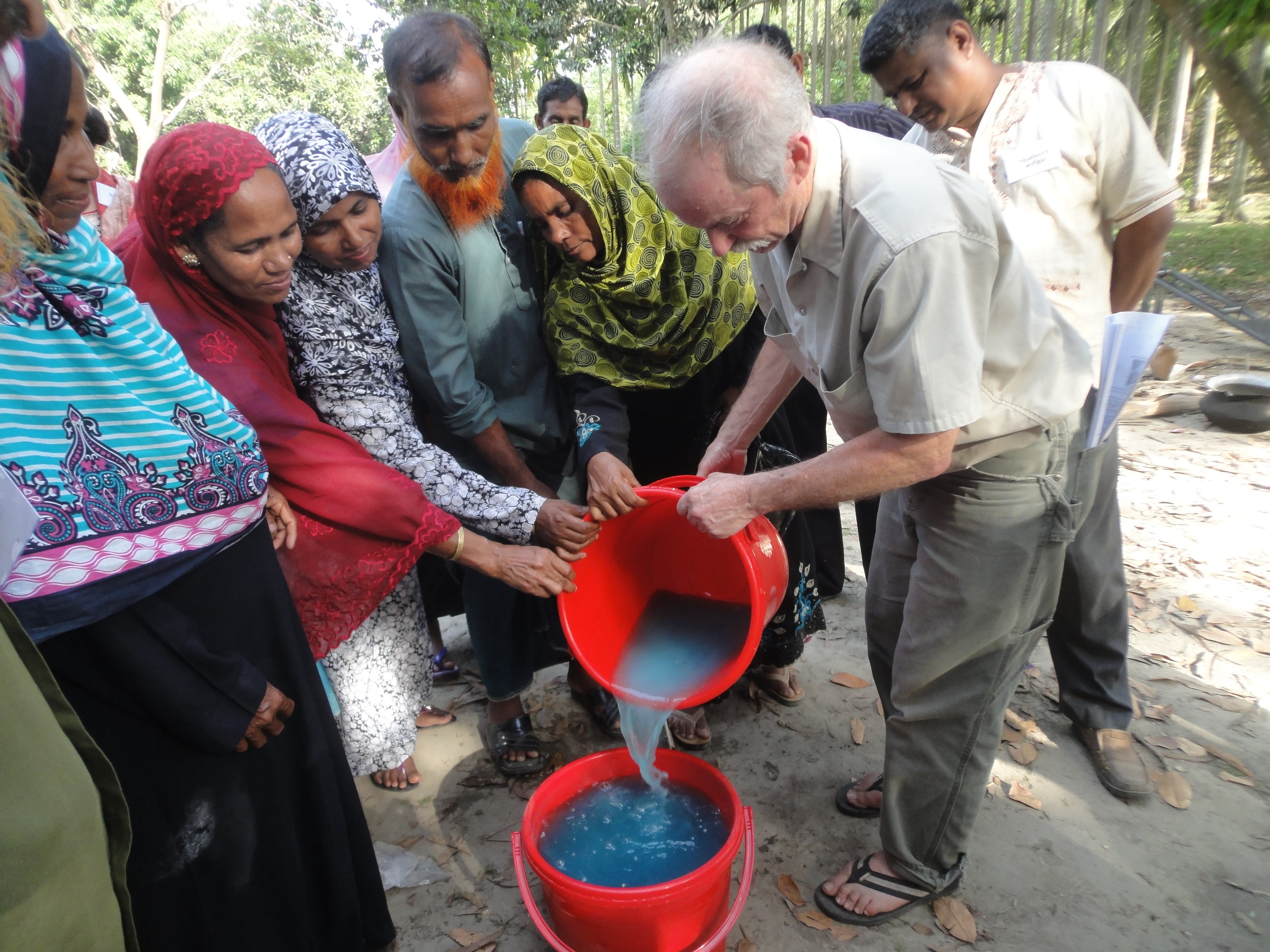 F2F volunteer Charles Mitchell demonstrates how to prepare an organic fungicide mixture to spray on vegetables to control fungal diseases
