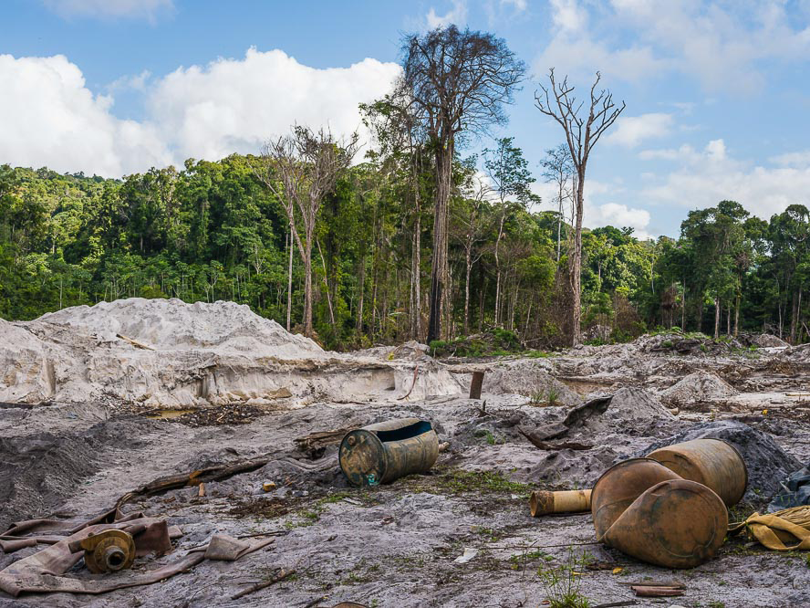 Gold mine along road between Linden and Lethem. Most dirt roads through the forest lead to a mine or logging concession. Gas stations sell mercury in reused soda bottles.